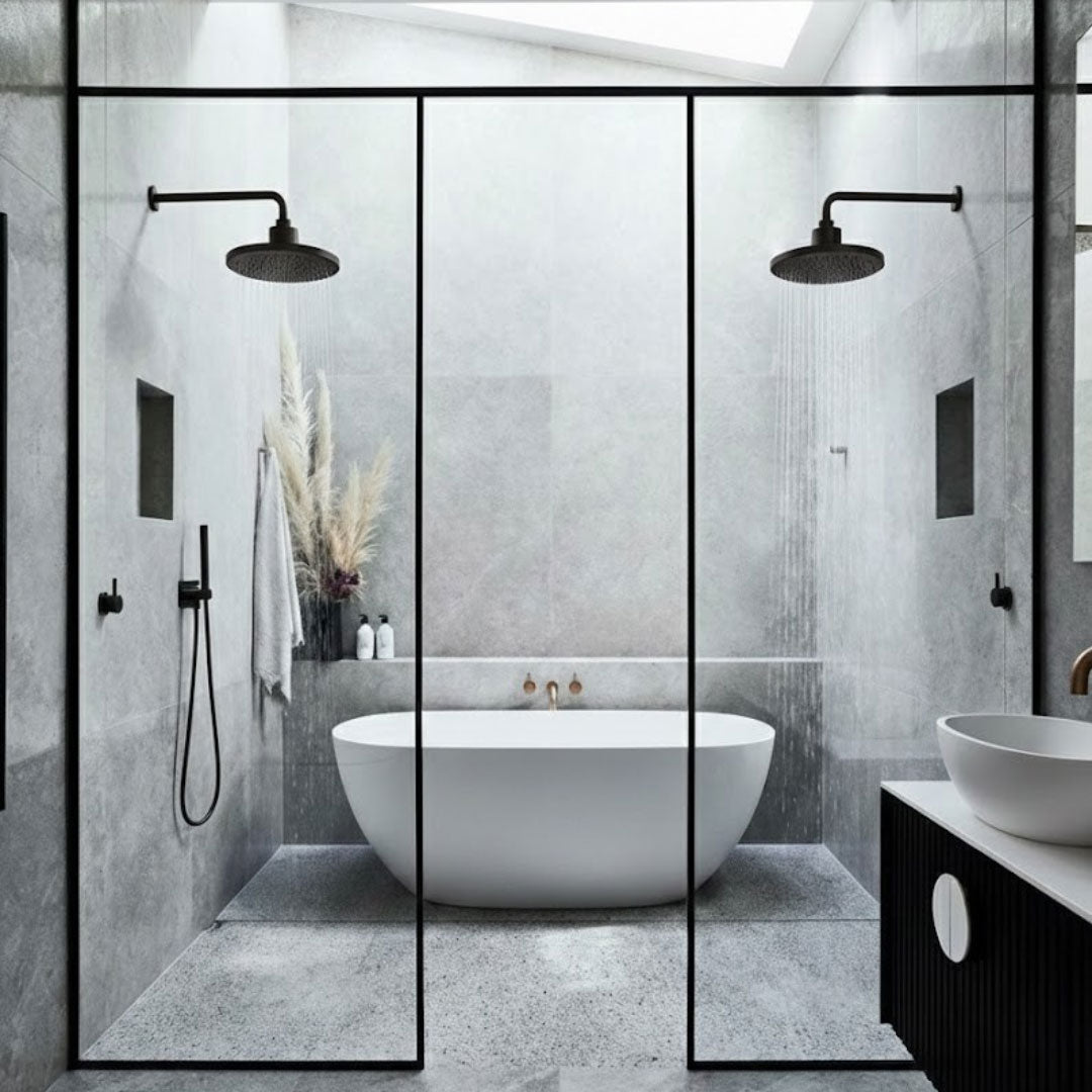 Modern bathroom with freestanding bathtub, glass shower enclosure, and black fixtures.